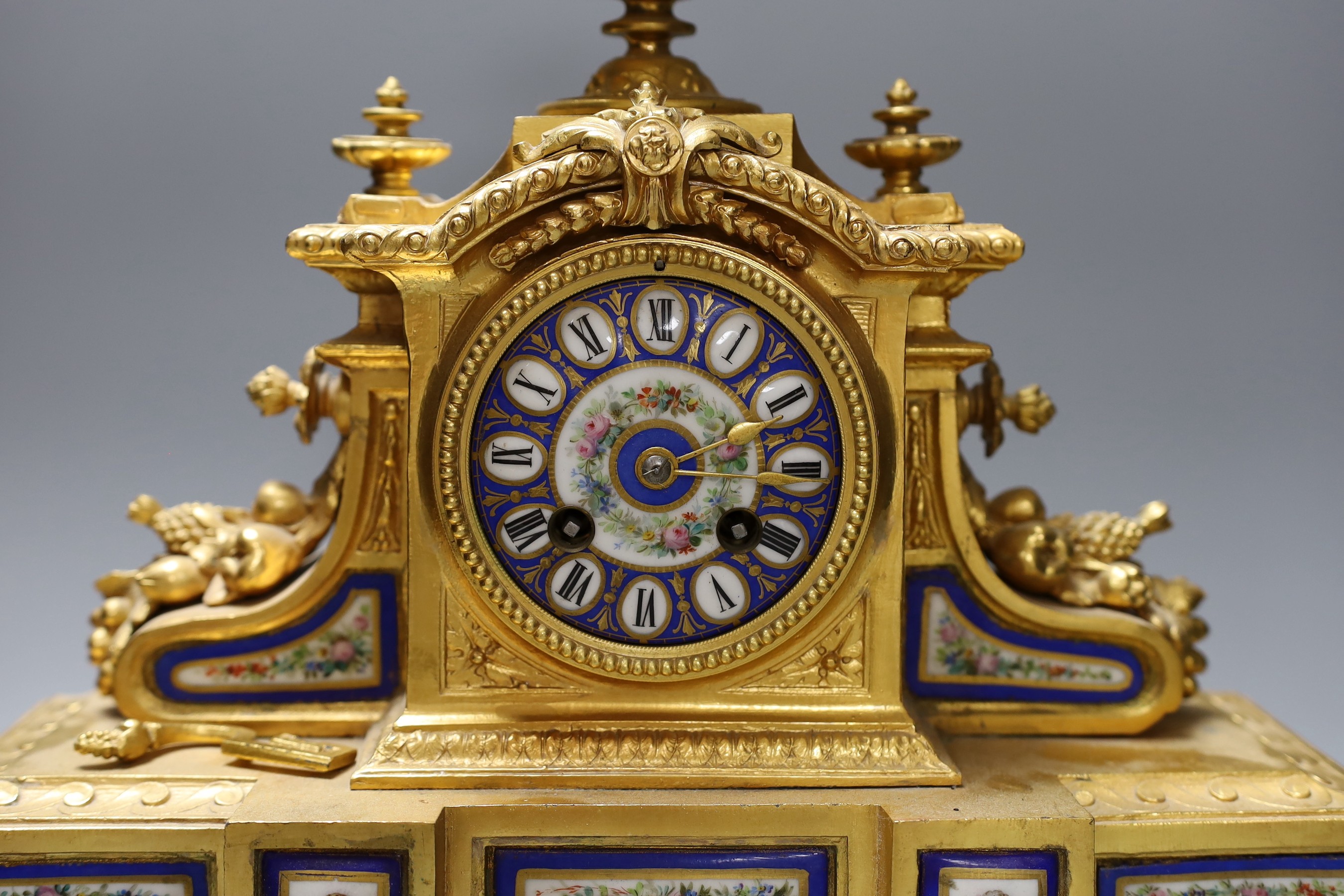 A 19th century French gilt metal and Sevres style enamel mantel clock, 37cm wide